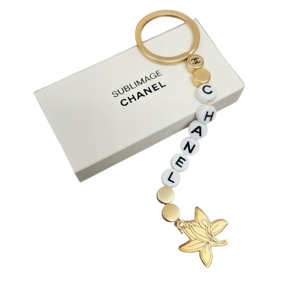 Sublimage Gold and White Camelia Floral Key achain/Bag Charm; NIB